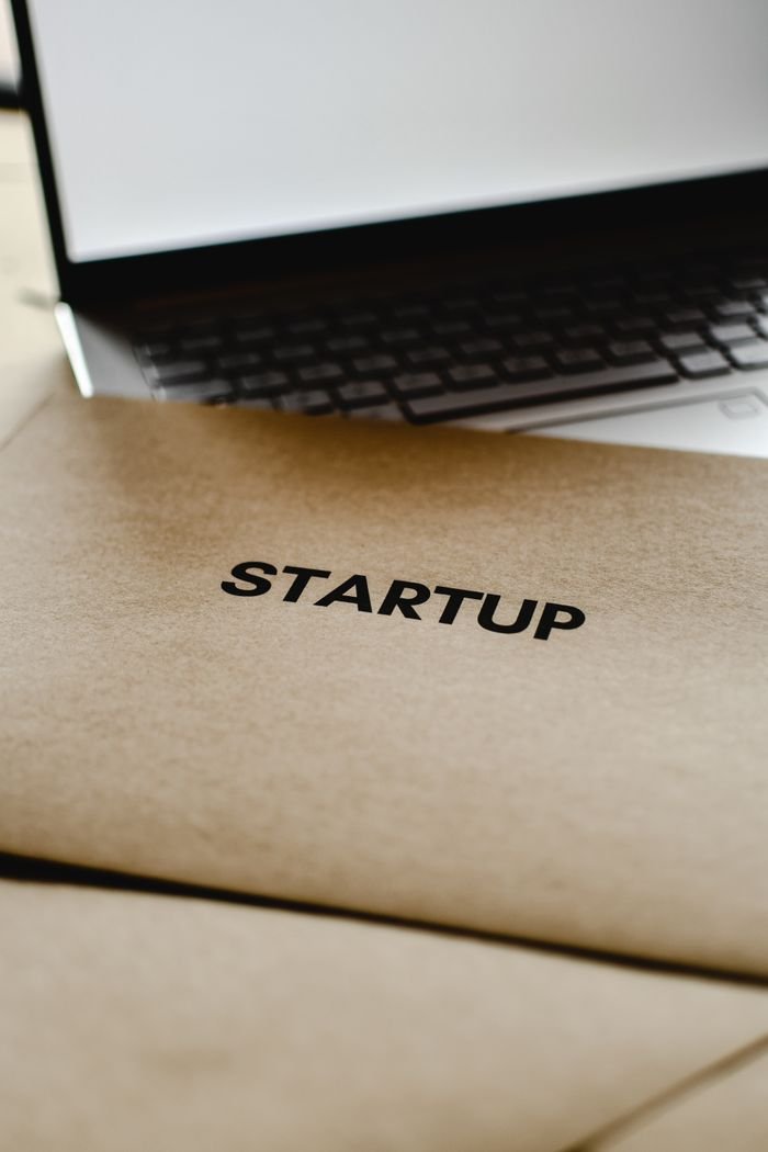 Home Close-up of a startup folder and laptop, representing business and technology innovation.