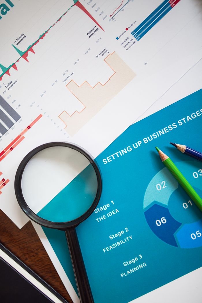 Home Magnifying glass and charts illustrate business analysis and planning concepts.